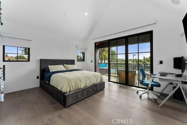 bedroom with high vaulted ceiling, access to exterior, and wood-type flooring