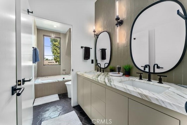 bathroom with toilet, vanity, and a relaxing tiled tub