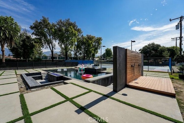 view of patio / terrace with a fenced in pool