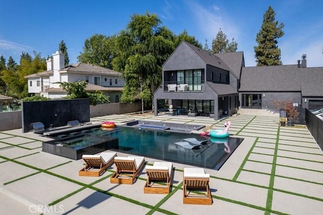 view of swimming pool with an in ground hot tub and a patio