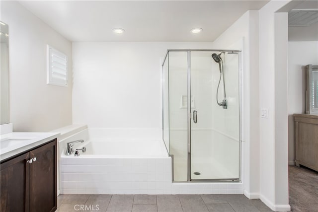 bathroom featuring shower with separate bathtub, vanity, and tile patterned flooring