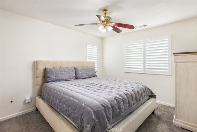 bedroom with ceiling fan and dark colored carpet