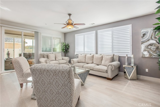 living room with ceiling fan and light wood-type flooring