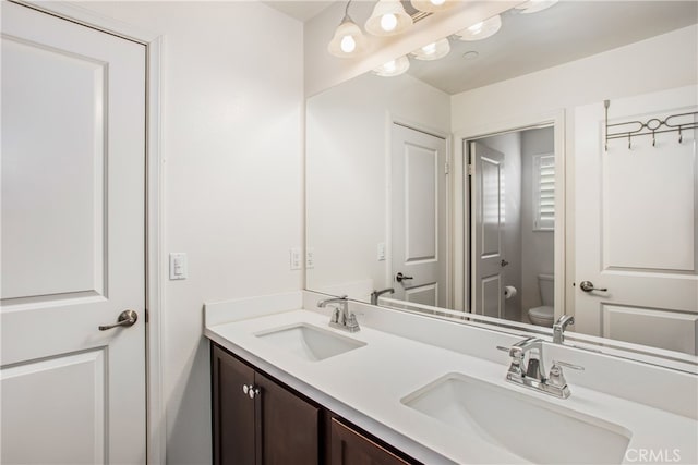 bathroom with toilet and vanity