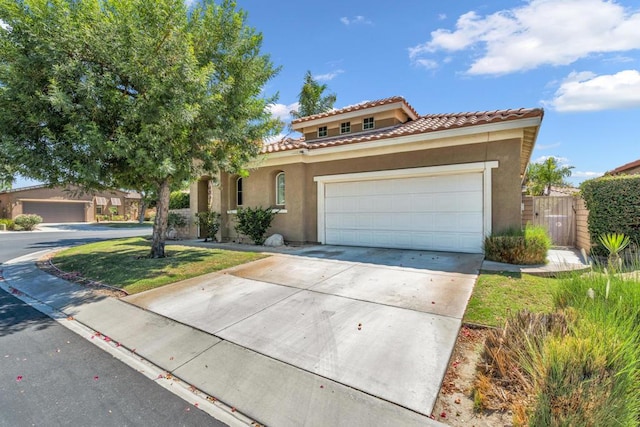 mediterranean / spanish-style home with a garage