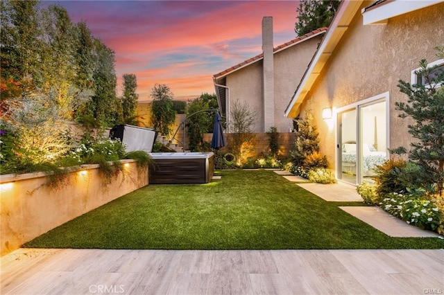 view of yard at dusk