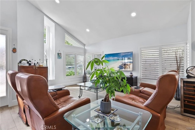 living room featuring light hardwood / wood-style floors, wine cooler, and vaulted ceiling