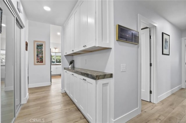 kitchen featuring white cabinetry and light wood-type flooring