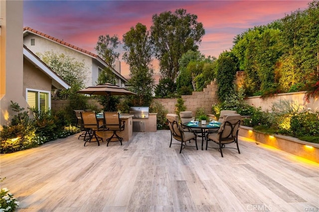 patio terrace at dusk with area for grilling