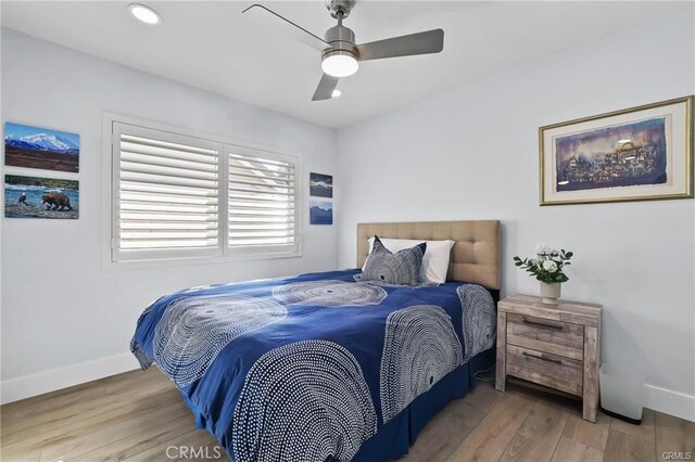 bedroom with ceiling fan and hardwood / wood-style flooring