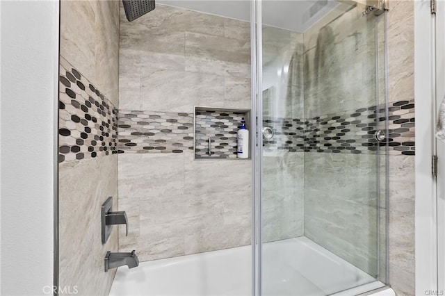 bathroom featuring combined bath / shower with glass door