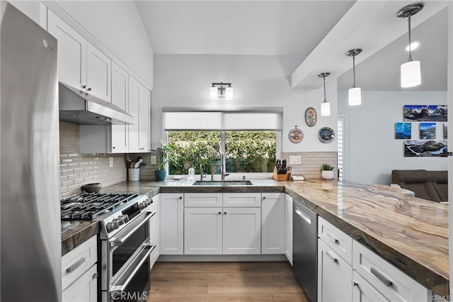 kitchen with kitchen peninsula, white cabinetry, and stainless steel appliances