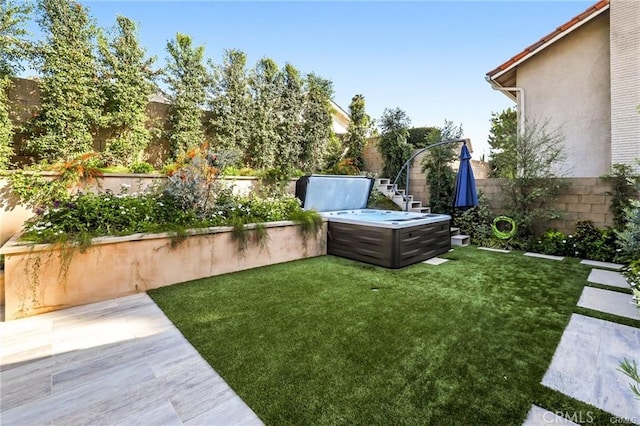 view of yard featuring a hot tub and a patio