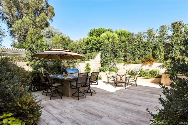 view of patio featuring a pergola, area for grilling, an outdoor kitchen, and exterior bar