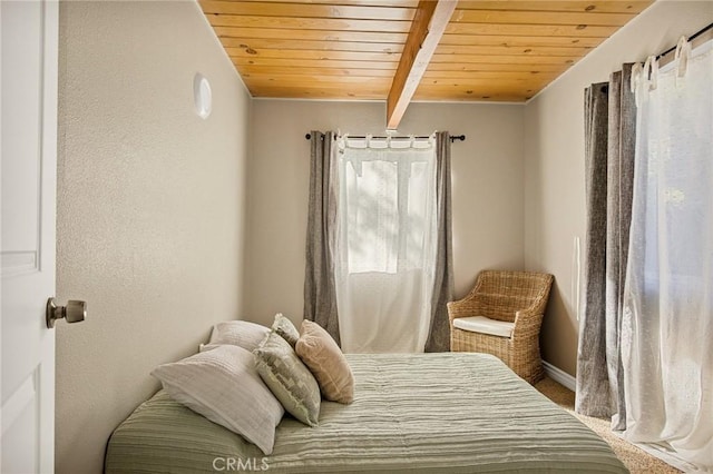 bedroom featuring wooden ceiling and beamed ceiling