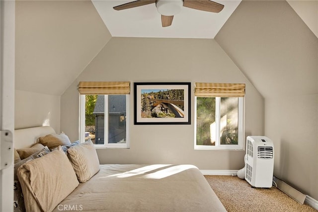 bedroom with ceiling fan, light colored carpet, and vaulted ceiling