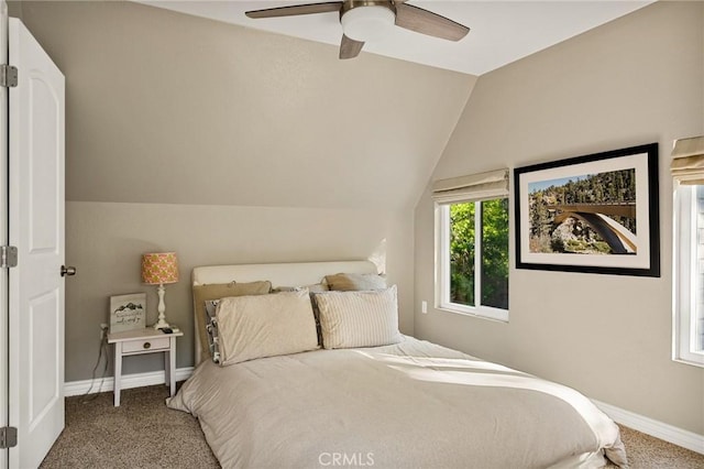 carpeted bedroom featuring ceiling fan and vaulted ceiling