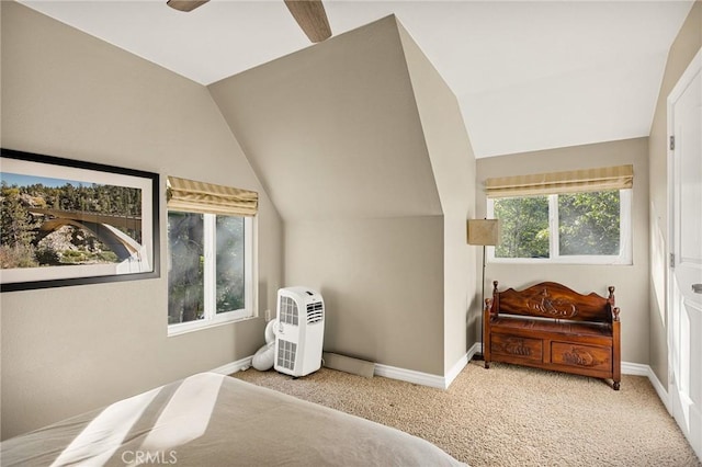 carpeted bedroom with ceiling fan and vaulted ceiling