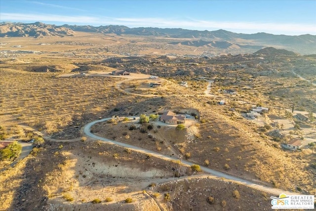 birds eye view of property featuring a mountain view