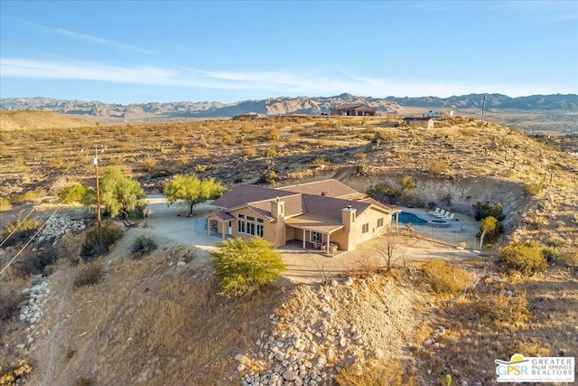 birds eye view of property with a mountain view