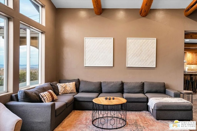 living room featuring beam ceiling