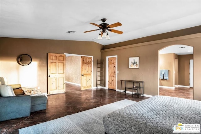 bedroom featuring ceiling fan, dark tile patterned flooring, and lofted ceiling