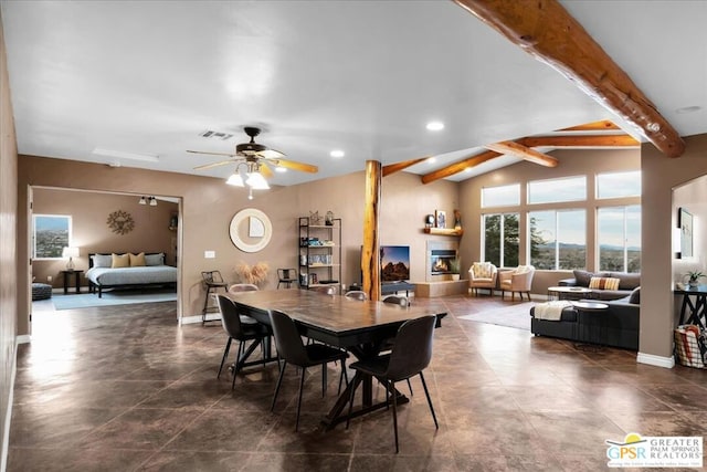 dining room with ceiling fan and vaulted ceiling with beams