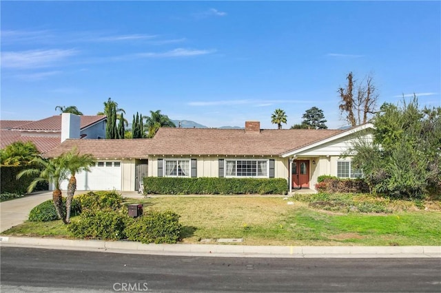 ranch-style house with a garage and a front lawn