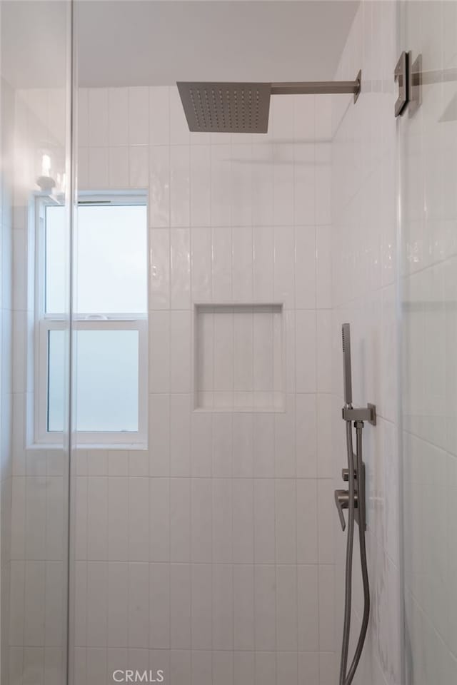 bathroom with a tile shower