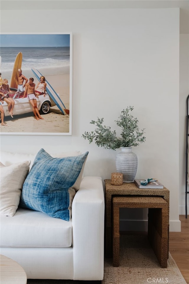 living area with hardwood / wood-style flooring and a water view