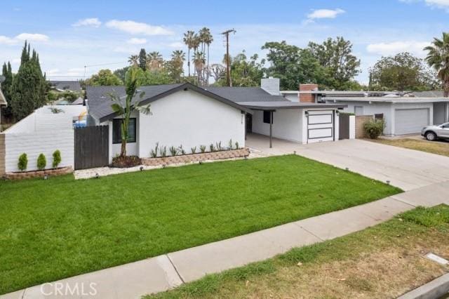 ranch-style house featuring a garage and a front lawn