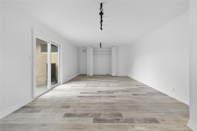 interior space featuring track lighting and light hardwood / wood-style floors