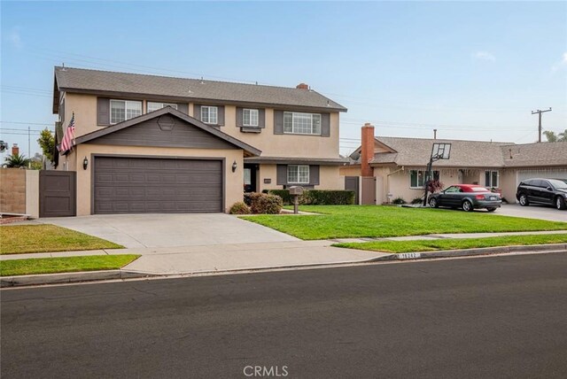 view of front of property featuring a garage and a front yard