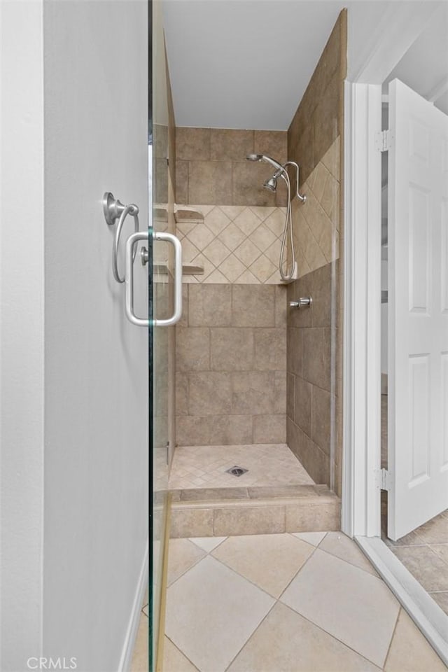 bathroom featuring a tile shower and tile patterned floors