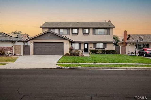 view of front of property featuring a yard and a garage