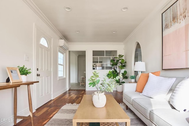 living room featuring an AC wall unit, dark hardwood / wood-style floors, and ornamental molding