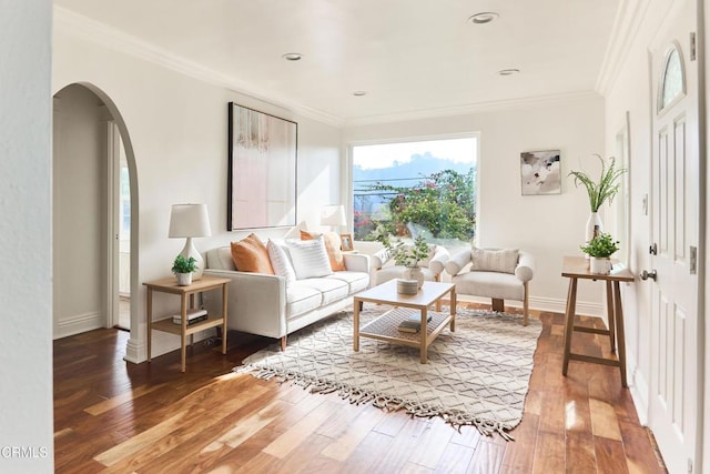 living room with dark wood-type flooring and ornamental molding