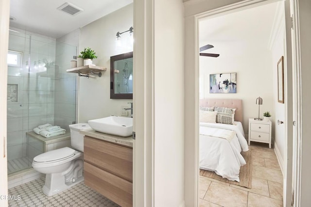 bathroom with tile patterned floors, vanity, a shower with door, toilet, and ceiling fan