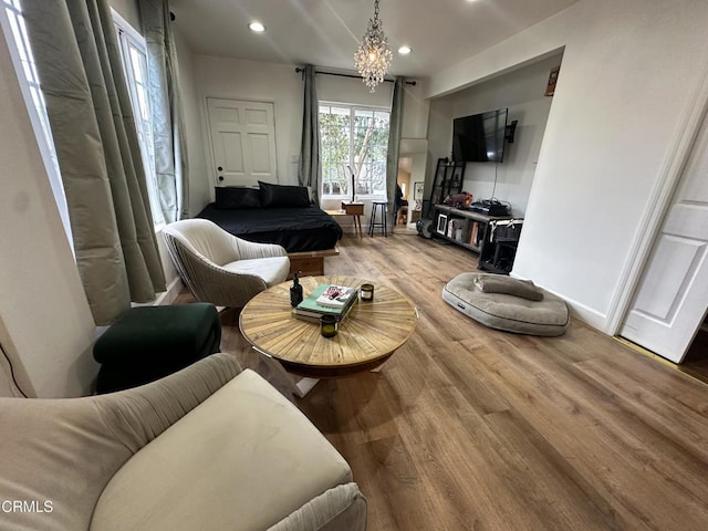 living room featuring wood-type flooring and a chandelier