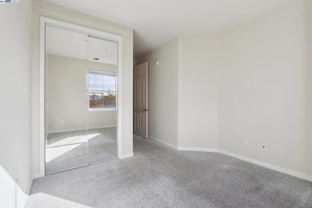 unfurnished bedroom with light colored carpet