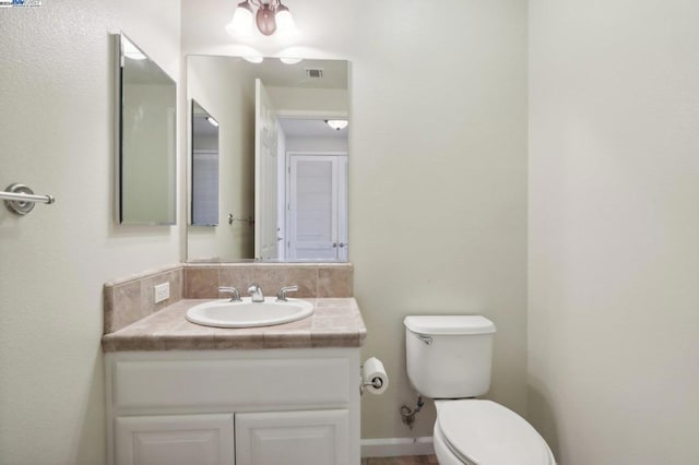 bathroom featuring toilet and vanity