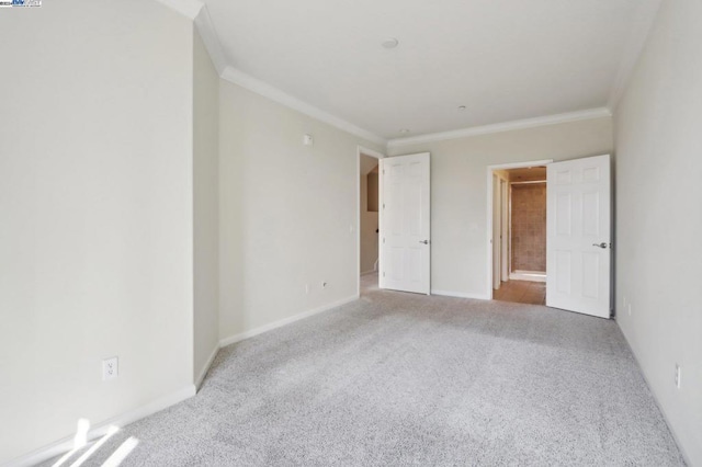 unfurnished bedroom with light colored carpet and crown molding