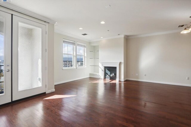 unfurnished living room featuring dark hardwood / wood-style floors and ornamental molding