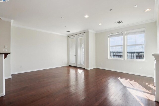 unfurnished living room with dark hardwood / wood-style flooring and crown molding