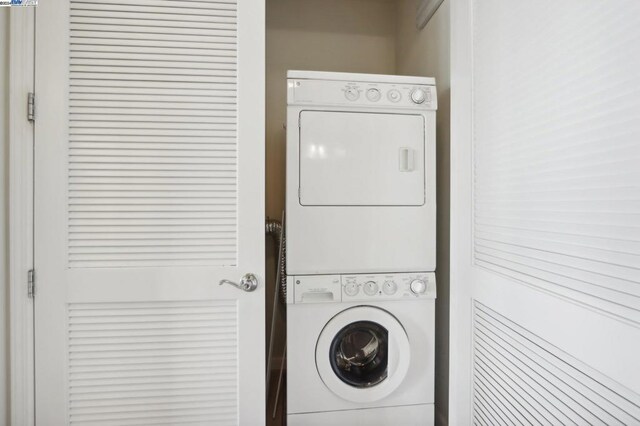 washroom featuring stacked washer and dryer