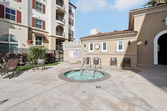 view of swimming pool with a hot tub