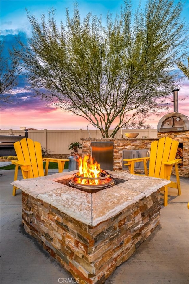 exterior details featuring an outdoor fire pit