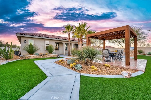 view of front of home featuring a lawn, cooling unit, a pergola, and a patio area