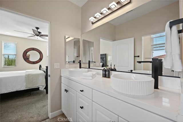 bathroom with ceiling fan, plenty of natural light, and vanity