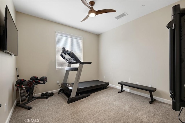 exercise room with ceiling fan and light colored carpet